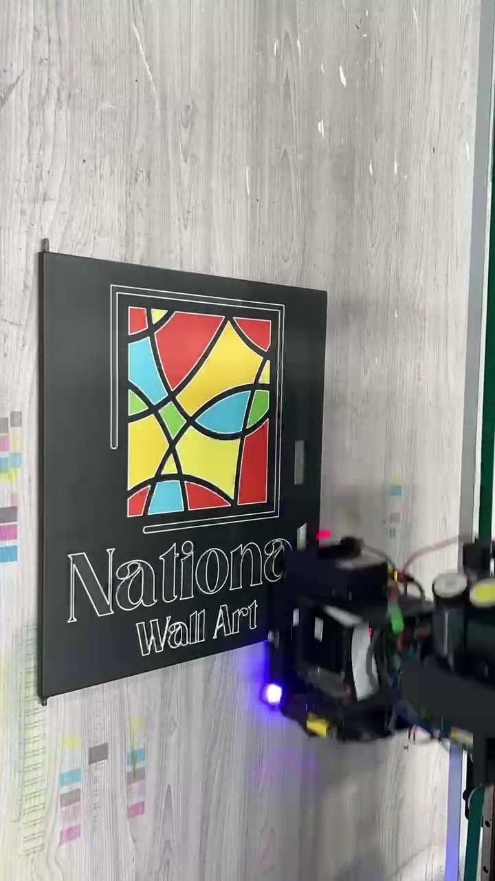 A finished full-color logo printed onto a dark panel by a vertical wall printer