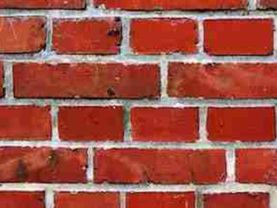 Exposed red brick with a mortar bed